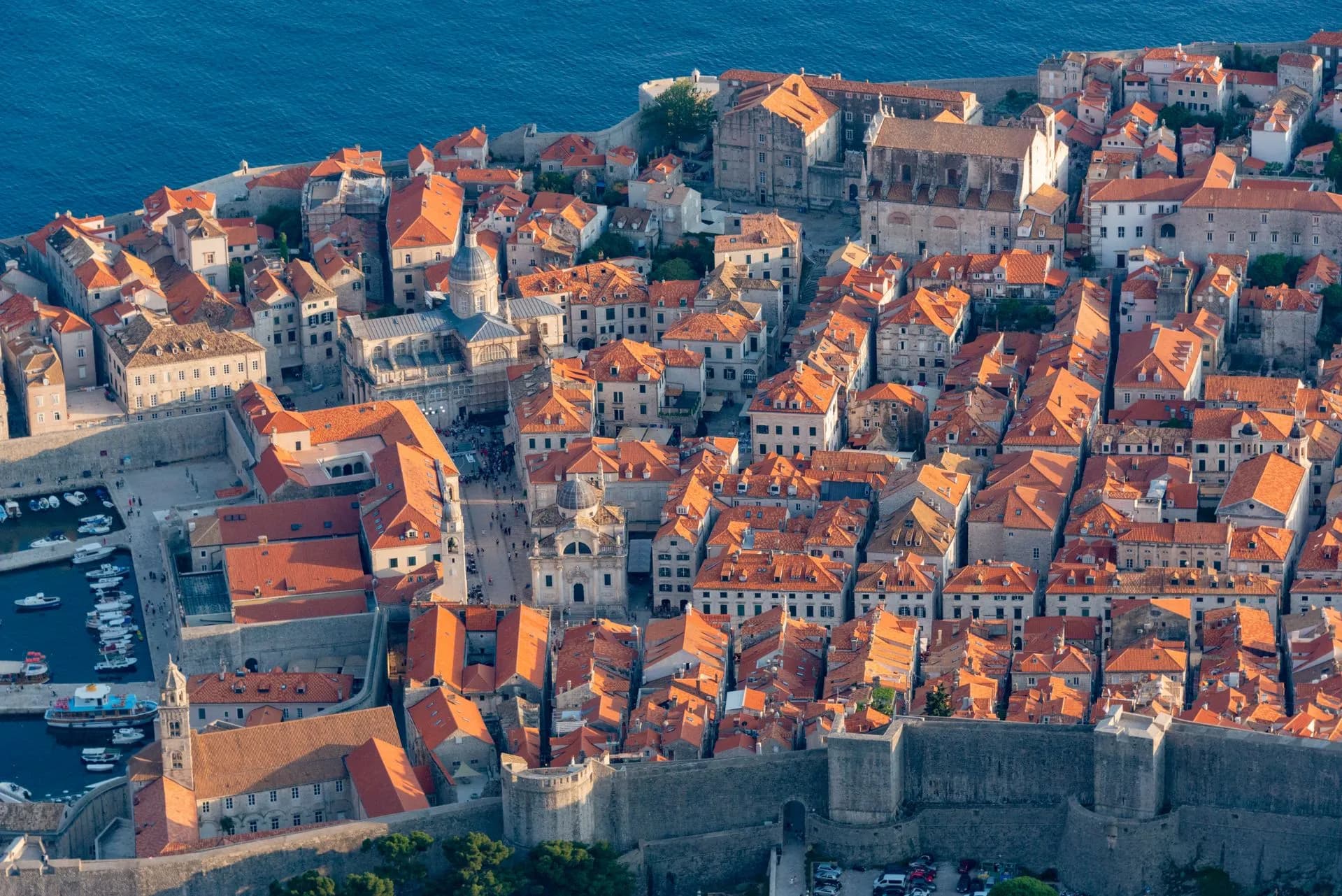 Terracotta rooftops of Dubrovnik's walled old town above the Adriatic seen from the city walls