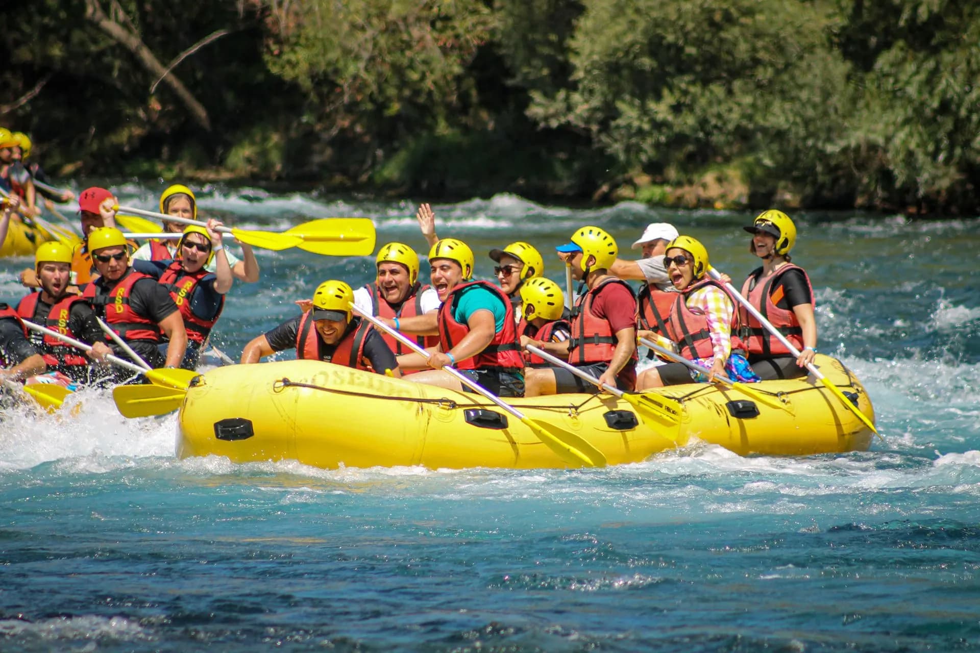Raft of paddlers running a rapid between limestone cliffs on the Cetina River near Omiš