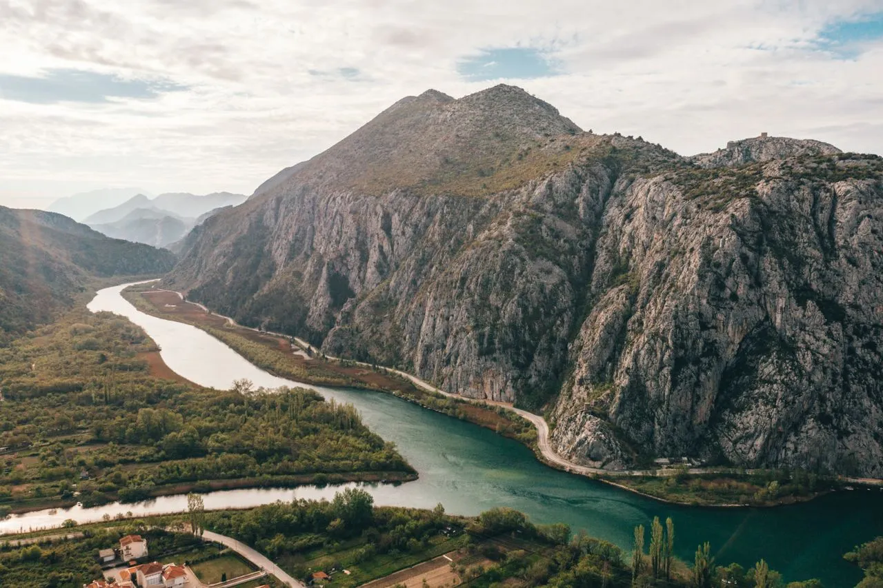 Aerial view of the turquoise Cetina River winding through its limestone canyon near Omiš